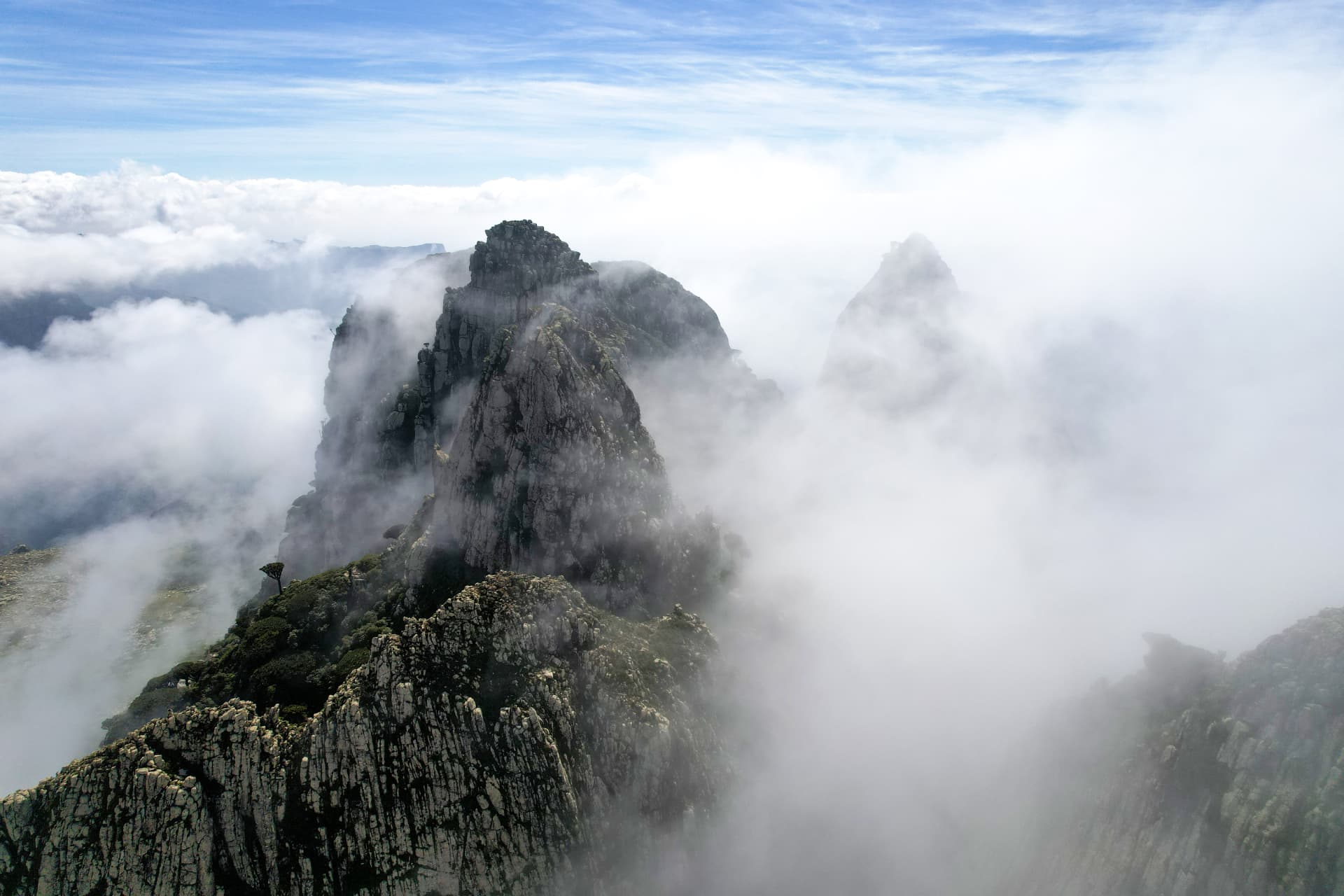 The granite peaks of the Hajhir Mountains rising above cloud on Socotra